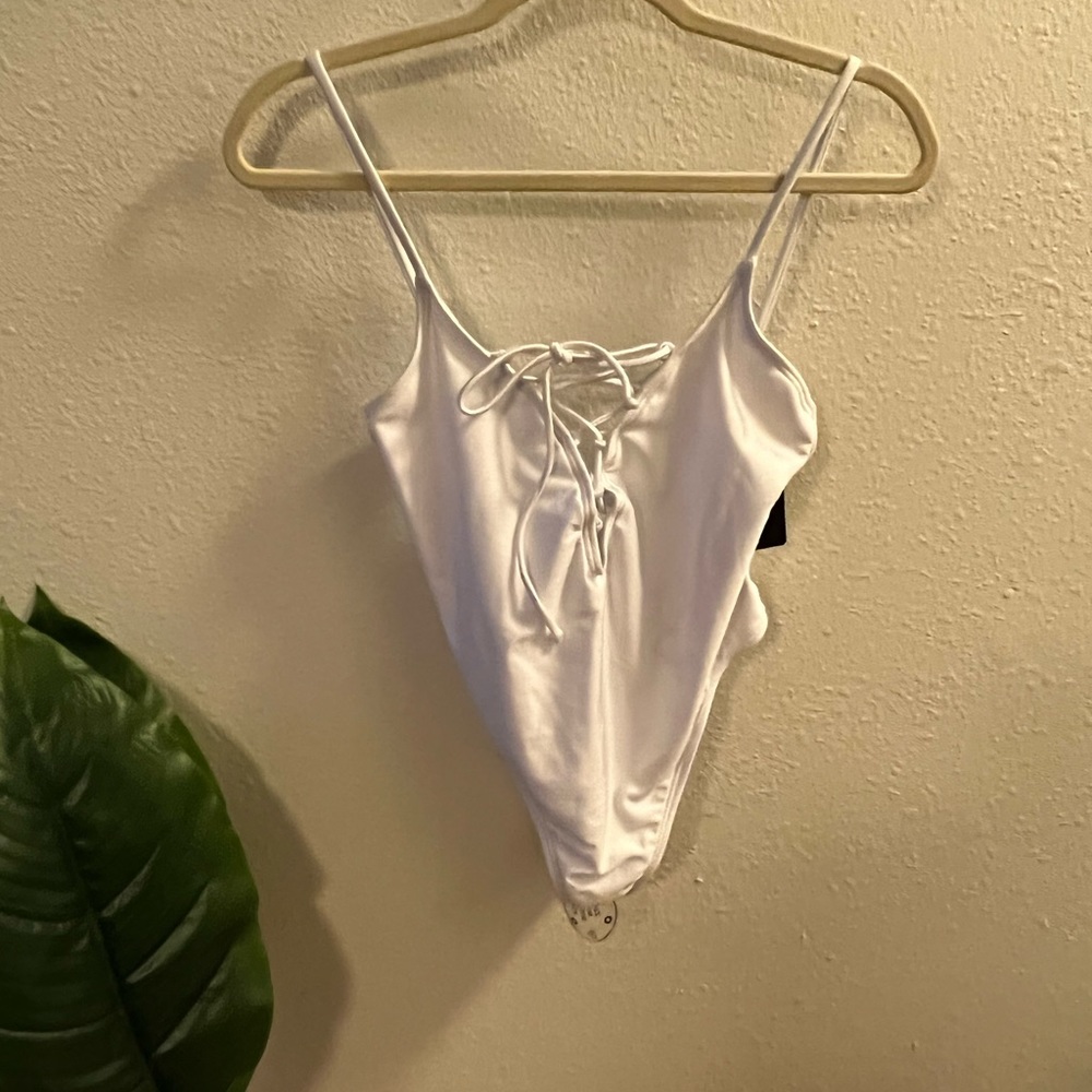 Lace up women’s white swim suit.